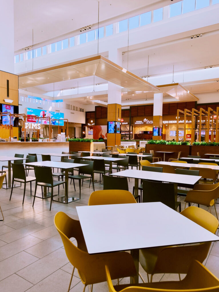 Contemporary food court interior design in a shopping mall with comfortable seating and vibrant dining spaces