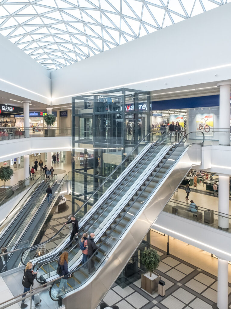Smart technology integration in shopping mall interiors with digital displays and interactive customer experiences