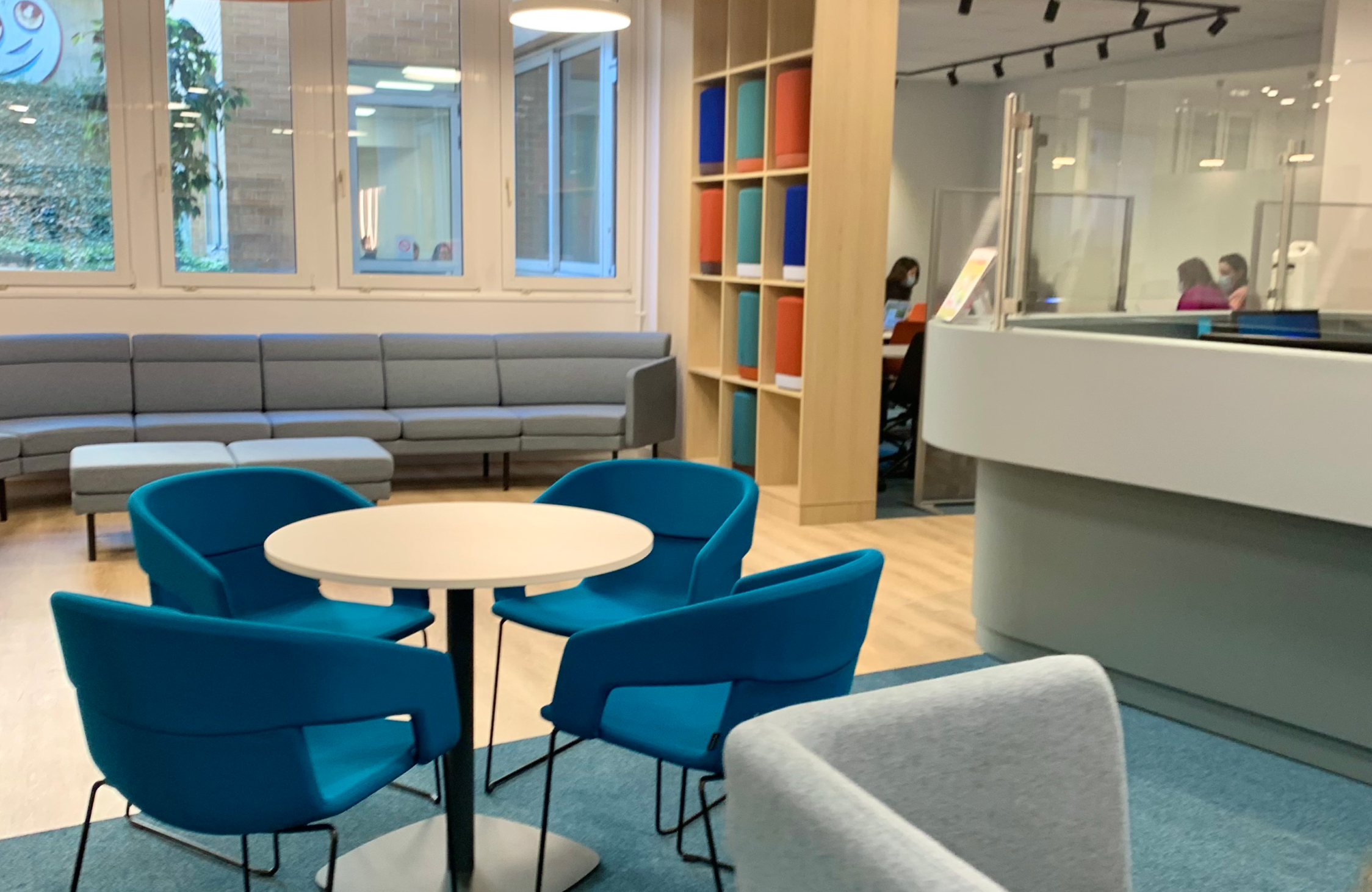 Modern coaching institute reception interior design in Ahmedabad featuring welcoming reception desk, branding, and comfortable waiting area