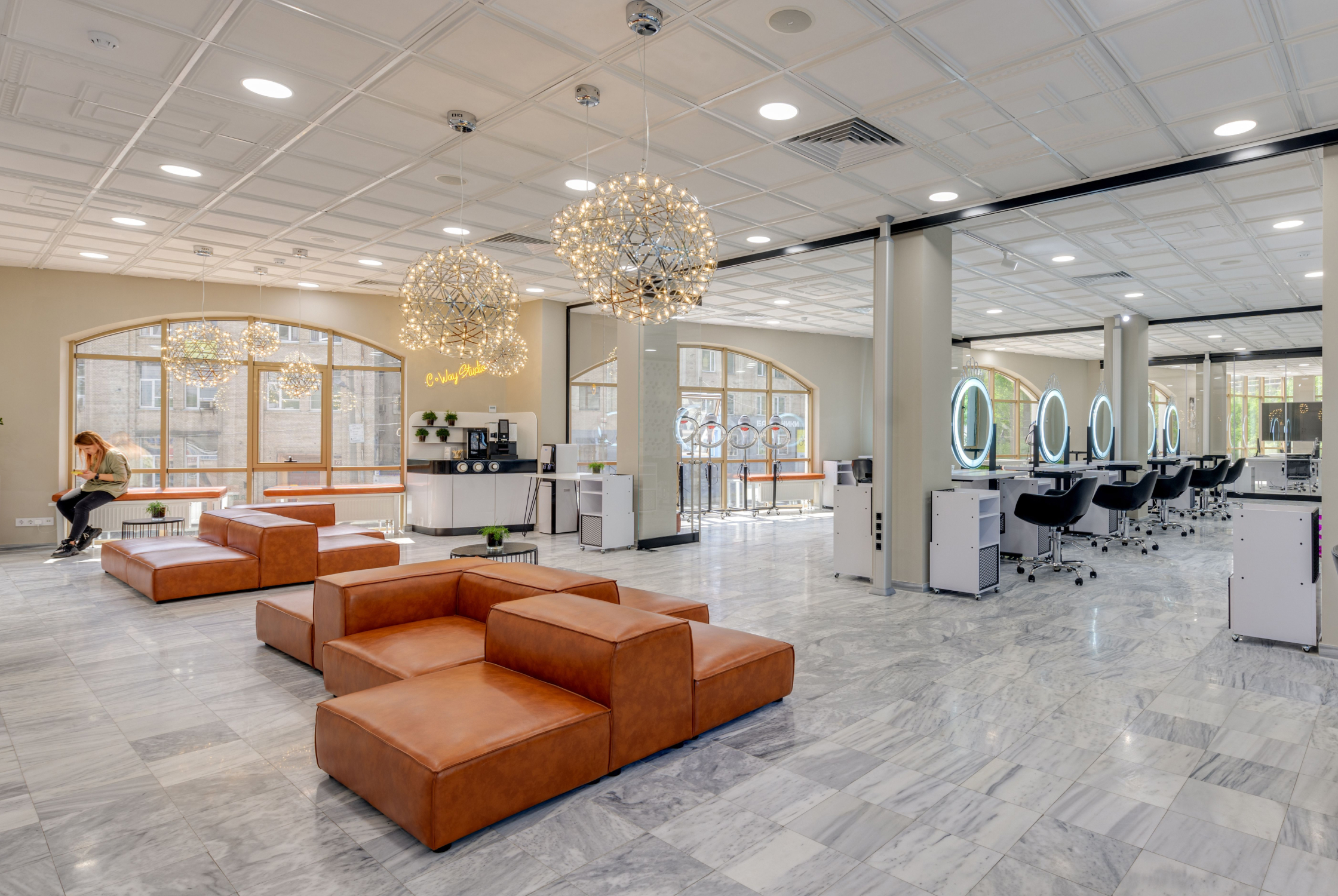 Modern hair salon interior design in Ahmedabad featuring premium styling chairs, mirrors, and contemporary lighting
