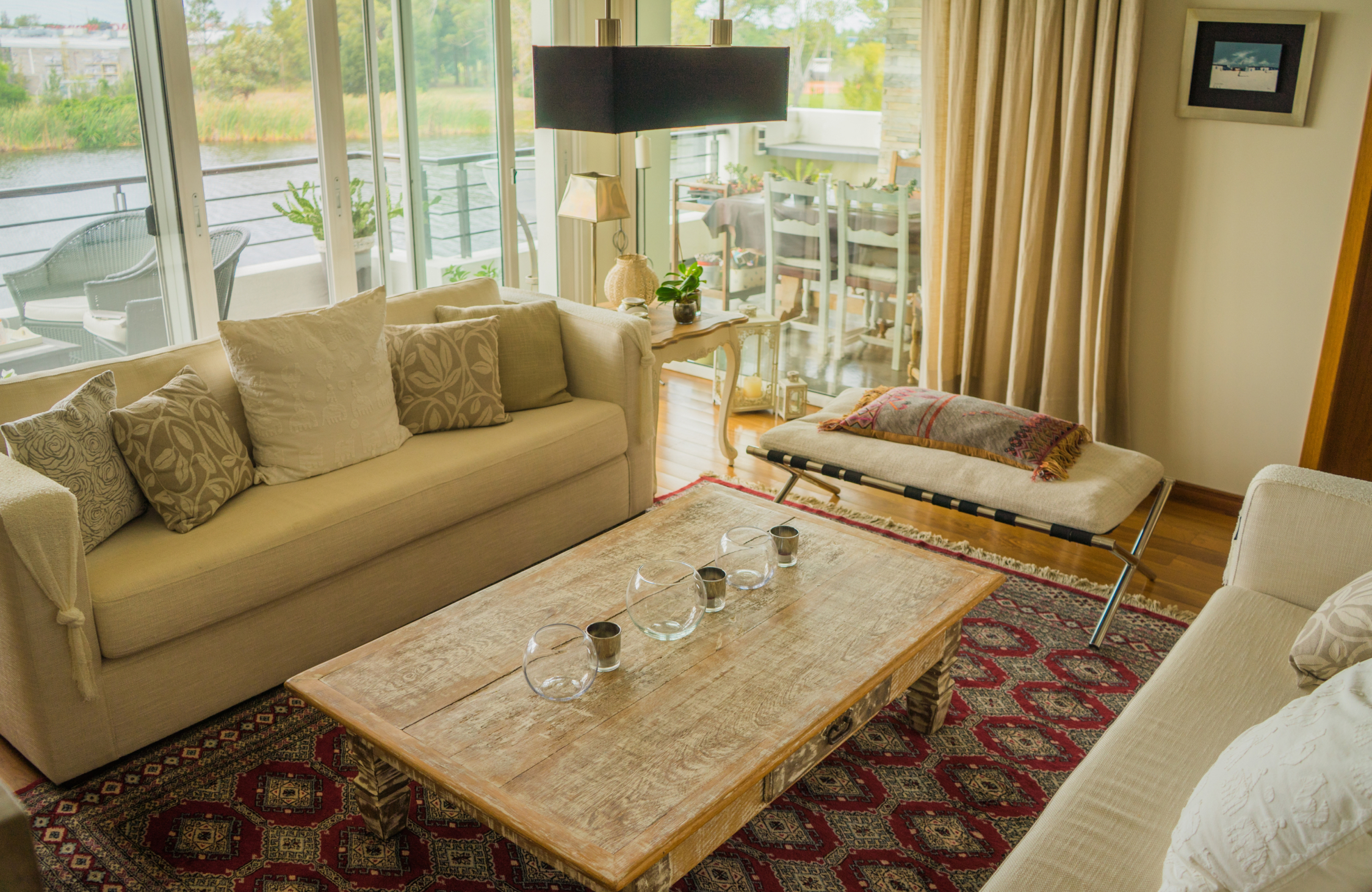 Comfortable luxury weekend home living room with spacious seating, natural light, premium finishes, and warm interiors.