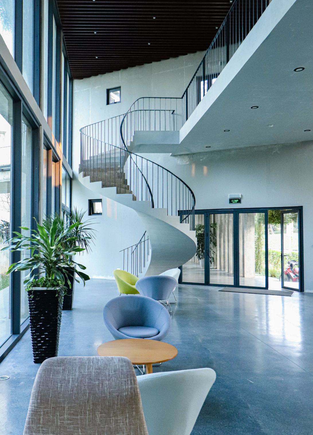 Luxury commercial interior with modern architecture, elegant seating, natural light, and sophisticated finishes.