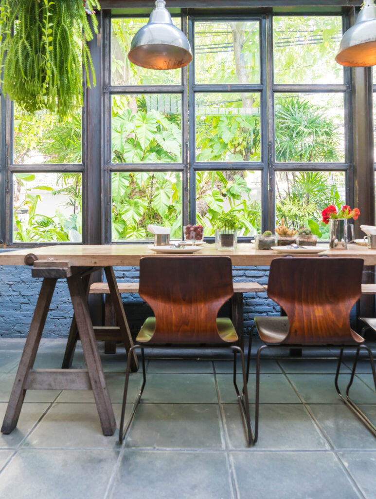 Luxury farmhouse dining area interior with statement pendant lighting and natural wood furniture