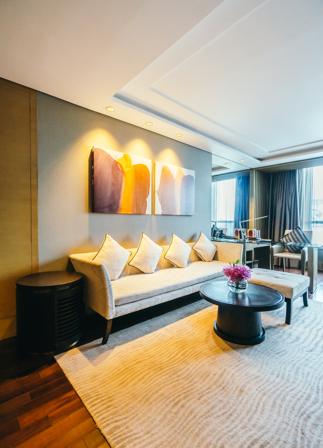 Luxury studio apartment living room with elegant furniture, warm lighting, and a sophisticated contemporary interior.