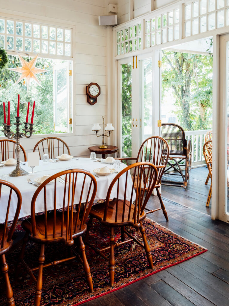 Relaxed weekend home dining area with natural light, wooden furniture, and an inviting interior setting.