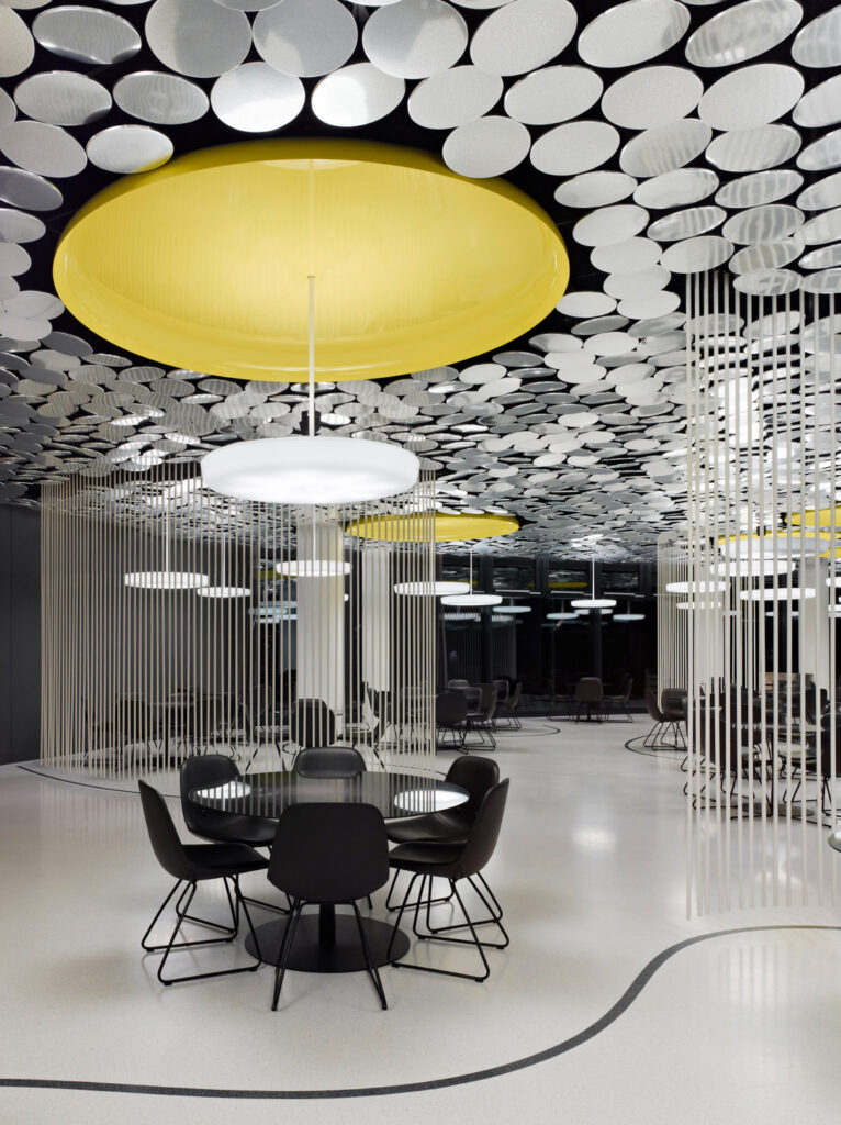 Turnkey commercial interior featuring statement lighting, modern furniture, functional planning, and sophisticated design details.