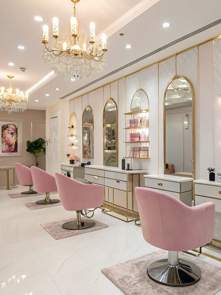 Elegant beauty salon interior with stylish styling stations, decorative lighting, mirrors, and comfortable seating.