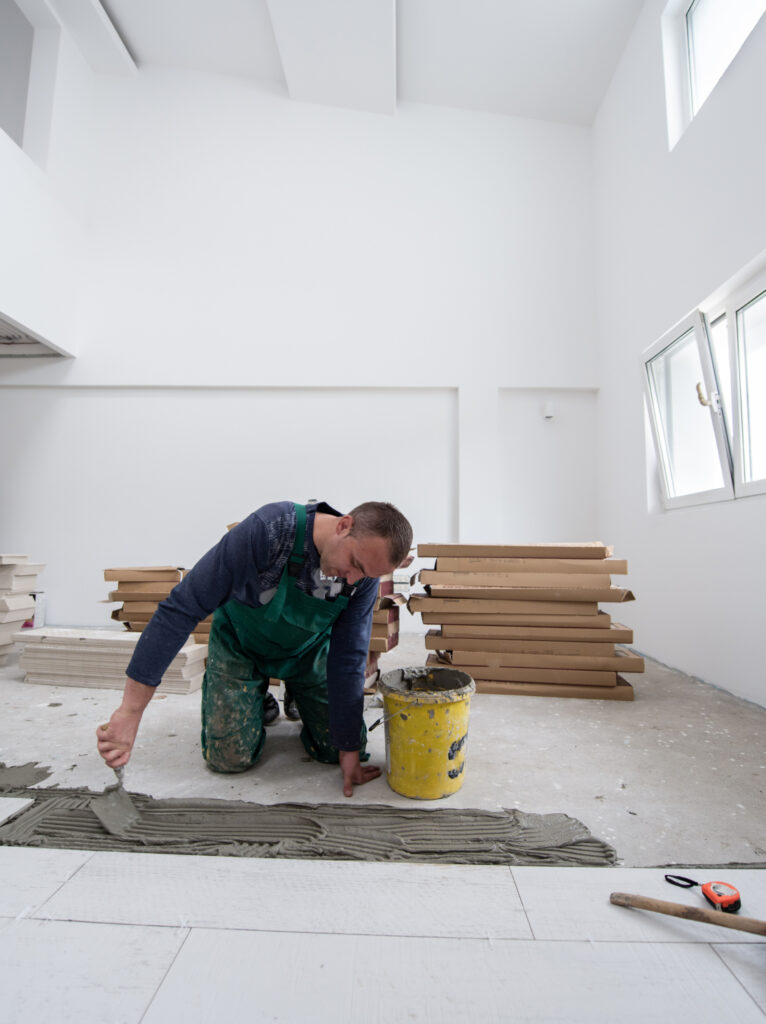 Home renovation planning with an architectural floor plan, design tools, and material samples.