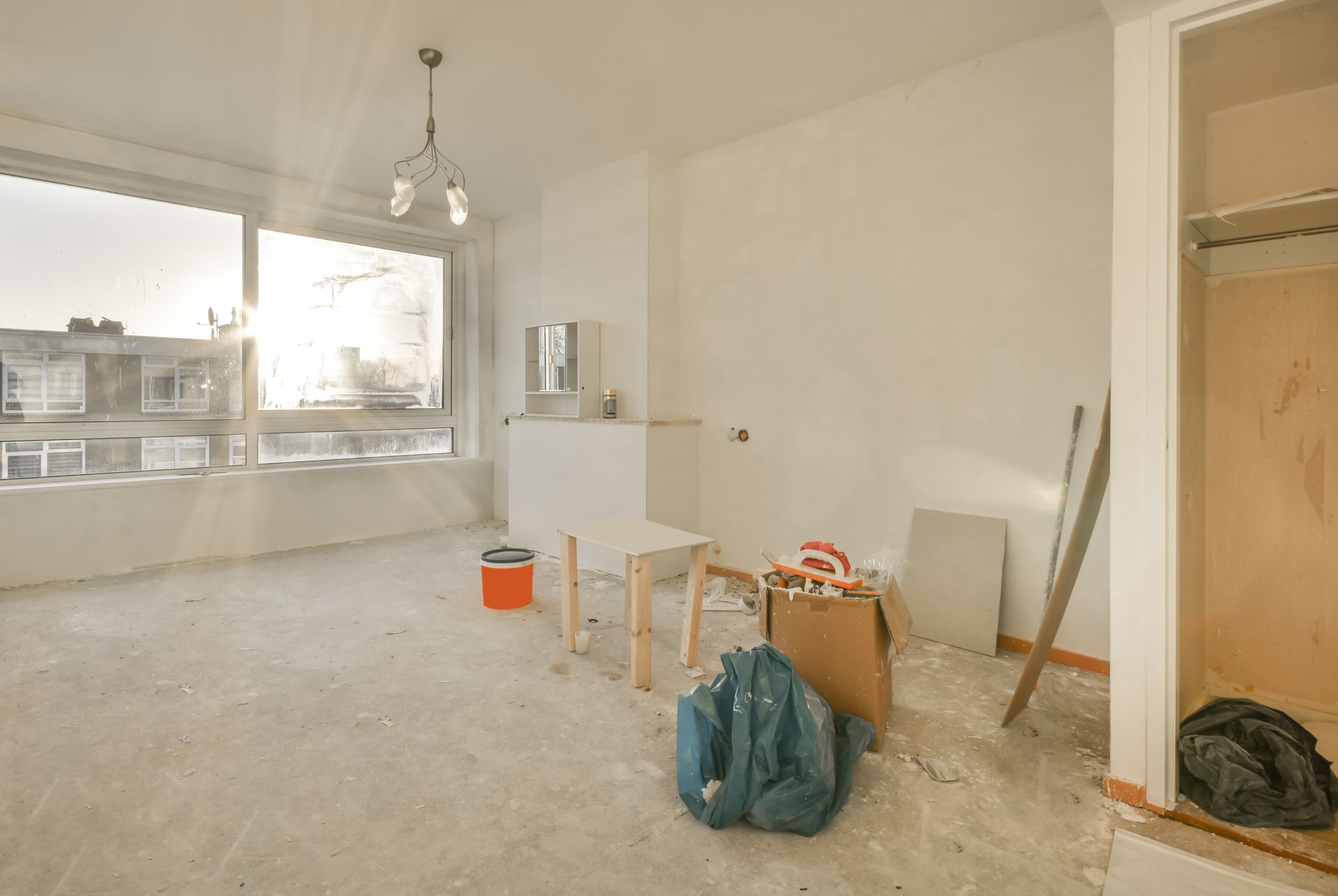 interior before renovation with unfinished spaces, construction materials, and areas prepared for redesign.