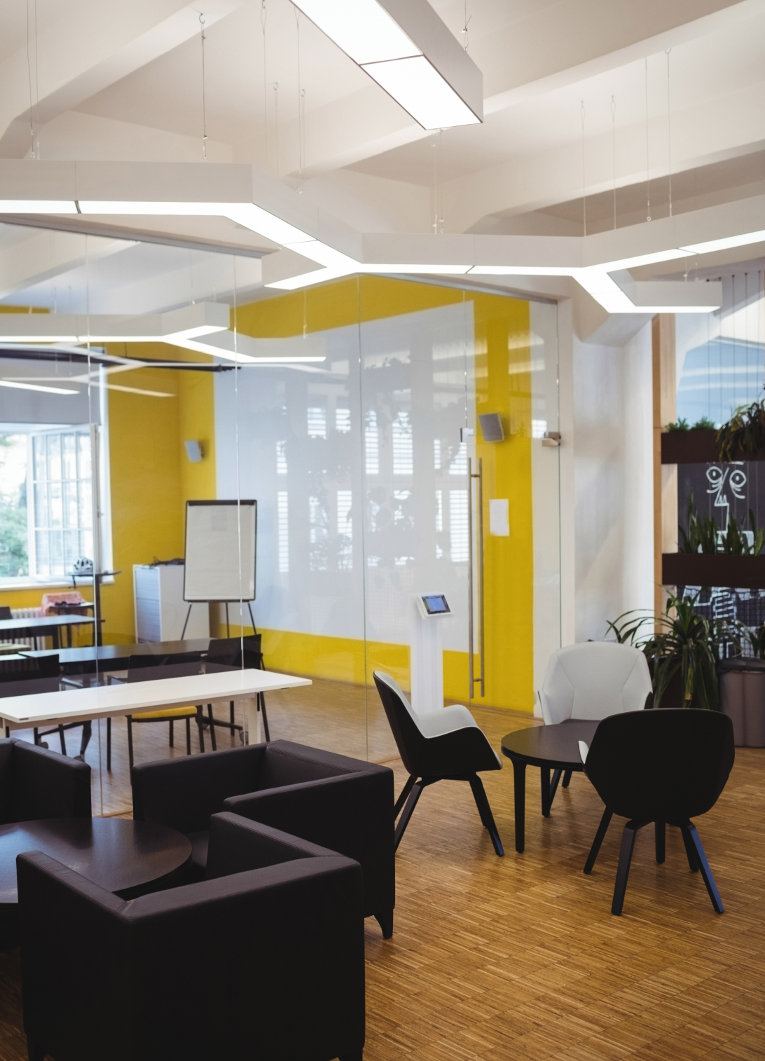 Modern office reception interior with contemporary furniture, decorative lighting, and a professional workspace design.
