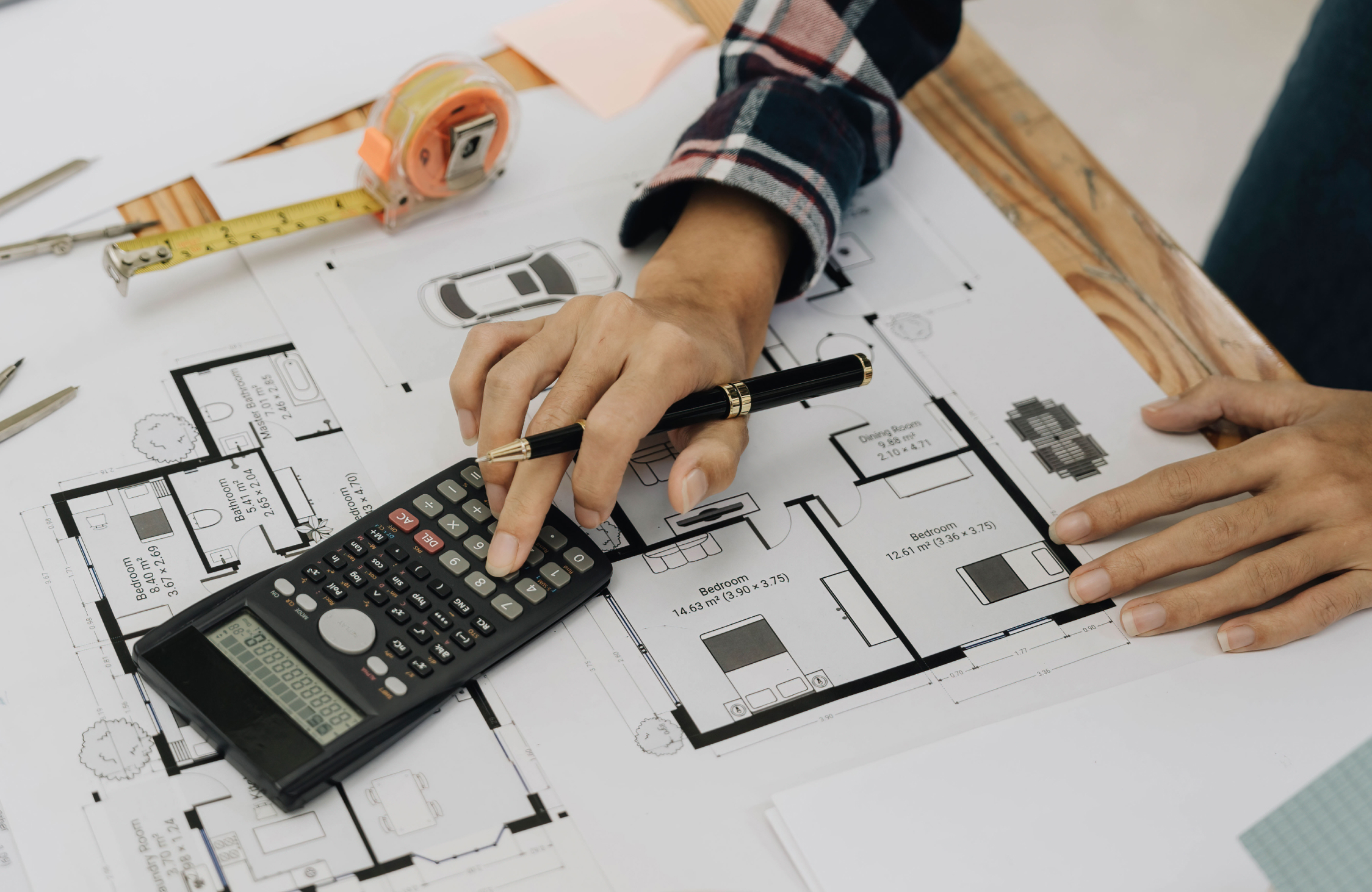 Interior designer reviewing architectural floor plans and measurements to plan a functional home interior.