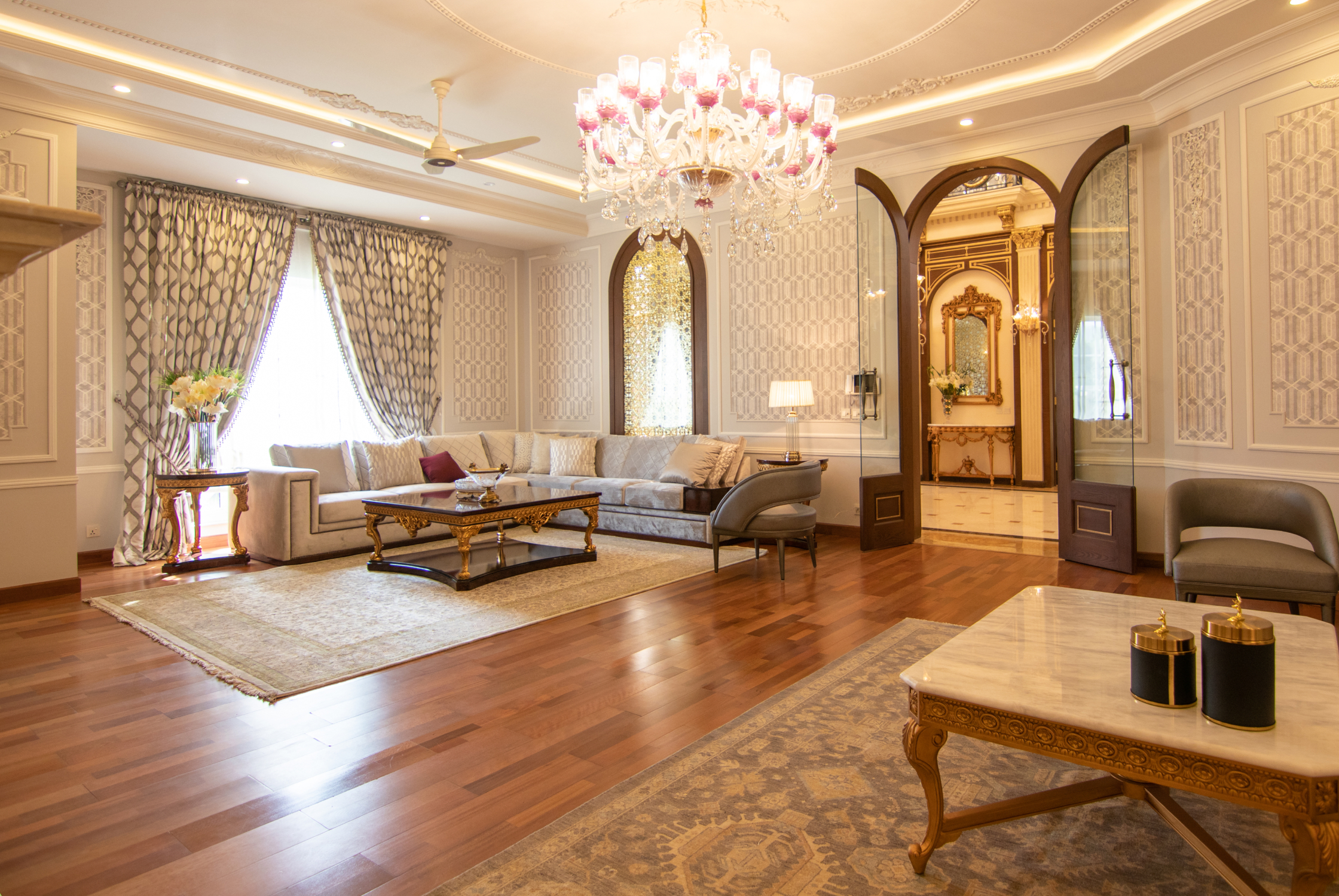 Luxury Vastu-friendly living room with sophisticated seating, warm lighting, traditional detailing, and spacious planning.