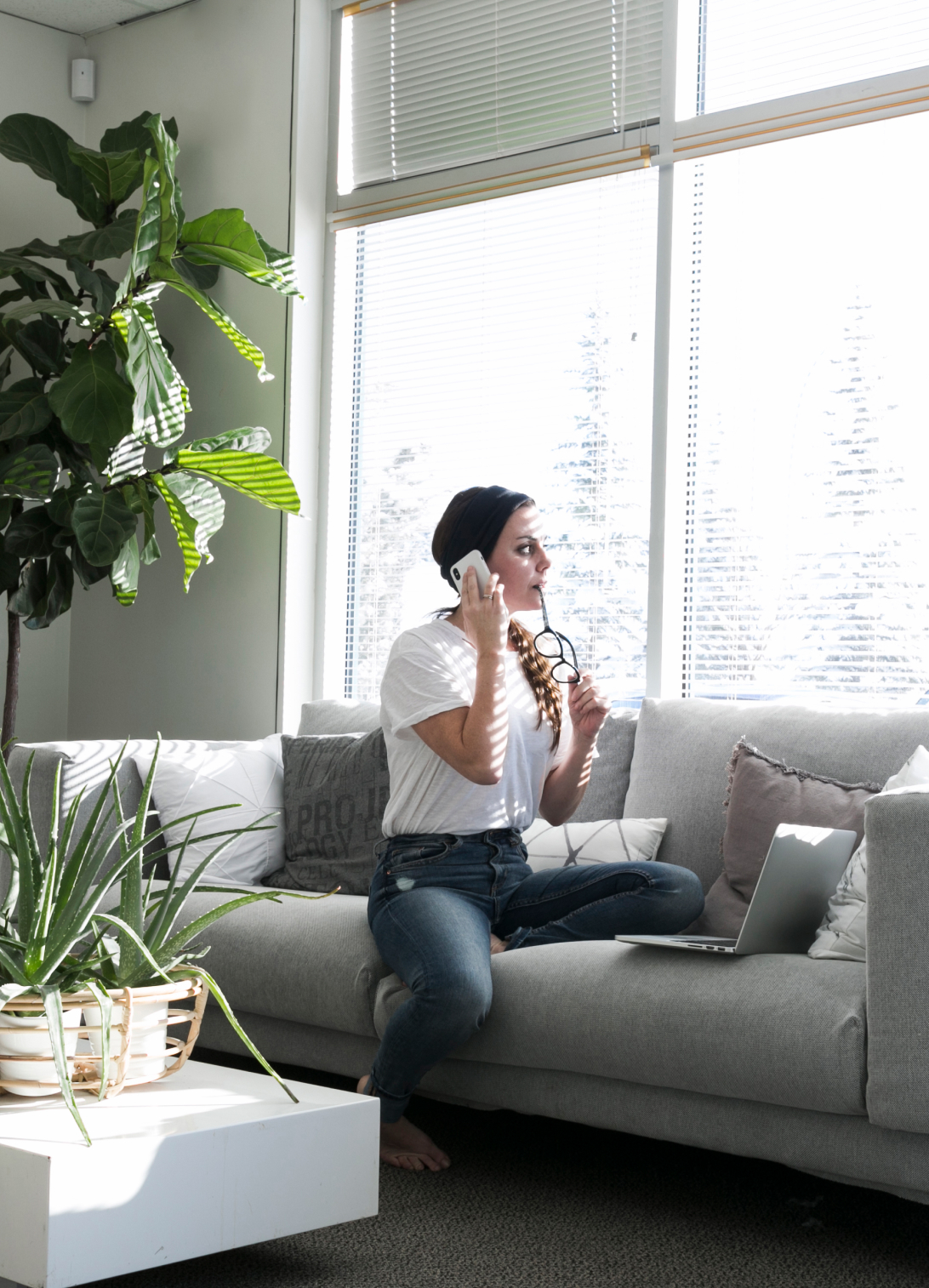 Sustainable home interior with natural light, indoor plants, comfortable furniture, and an eco-conscious modern design.