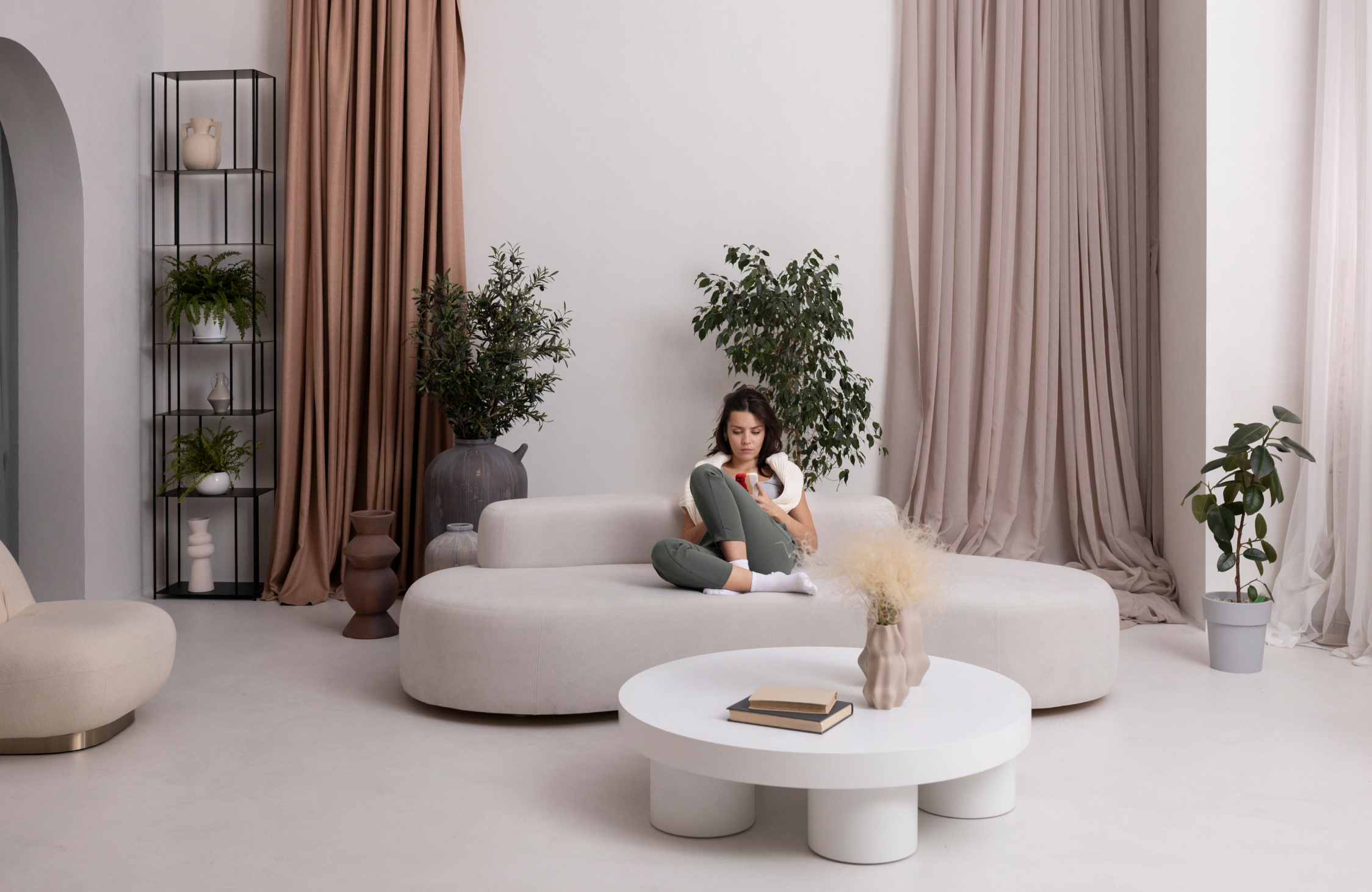 Contemporary Vastu-friendly living room with curved furniture, soft neutral colours, natural light, and sophisticated styling.