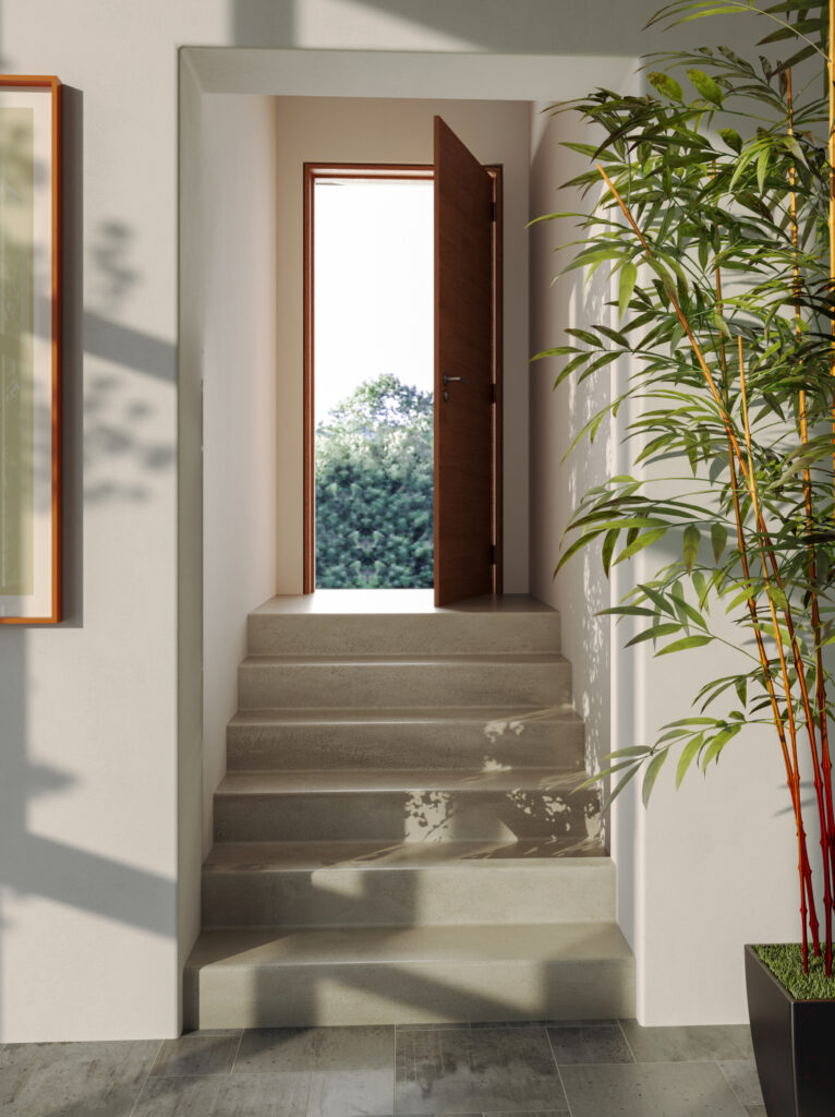 Vastu-friendly home entrance with a clean staircase, natural light, indoor plants, and an inviting modern design.